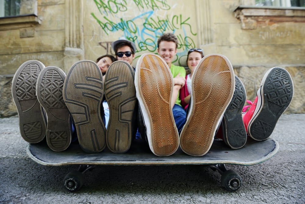 Urban stylish trendy young teenage people with legs on skate-2
